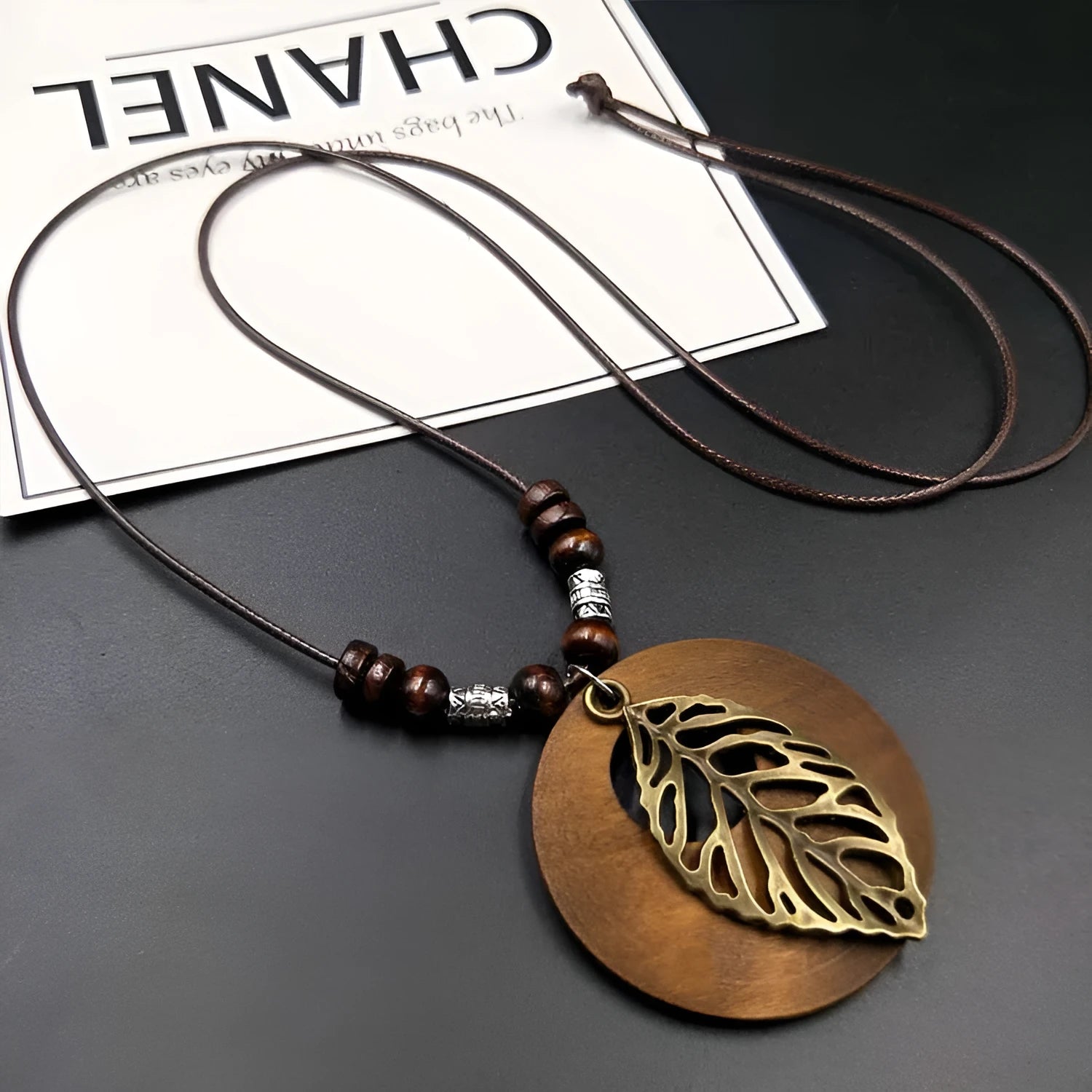 Adjustable wooden leaf necklace with ethnic styling on cotton-linen cord