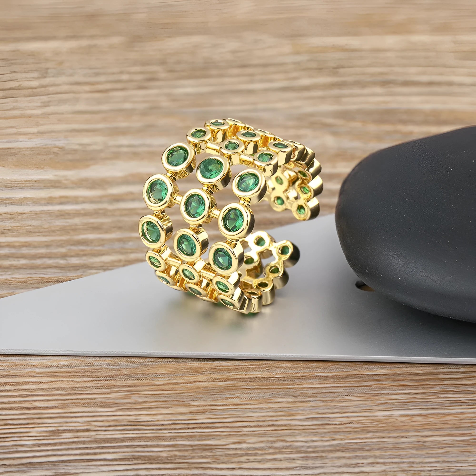 Copper wide band ring plated in 18K gold, fully set with green zircon stones.