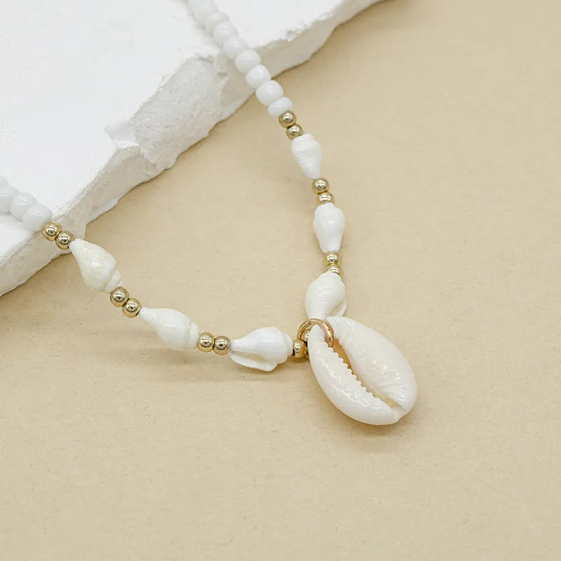 White mother pearl shellfish conch bead necklace with electroplated finish and shell pendant on regular chain