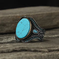 Men's round turquoise alloy ring with antique silver finish showing circular band design