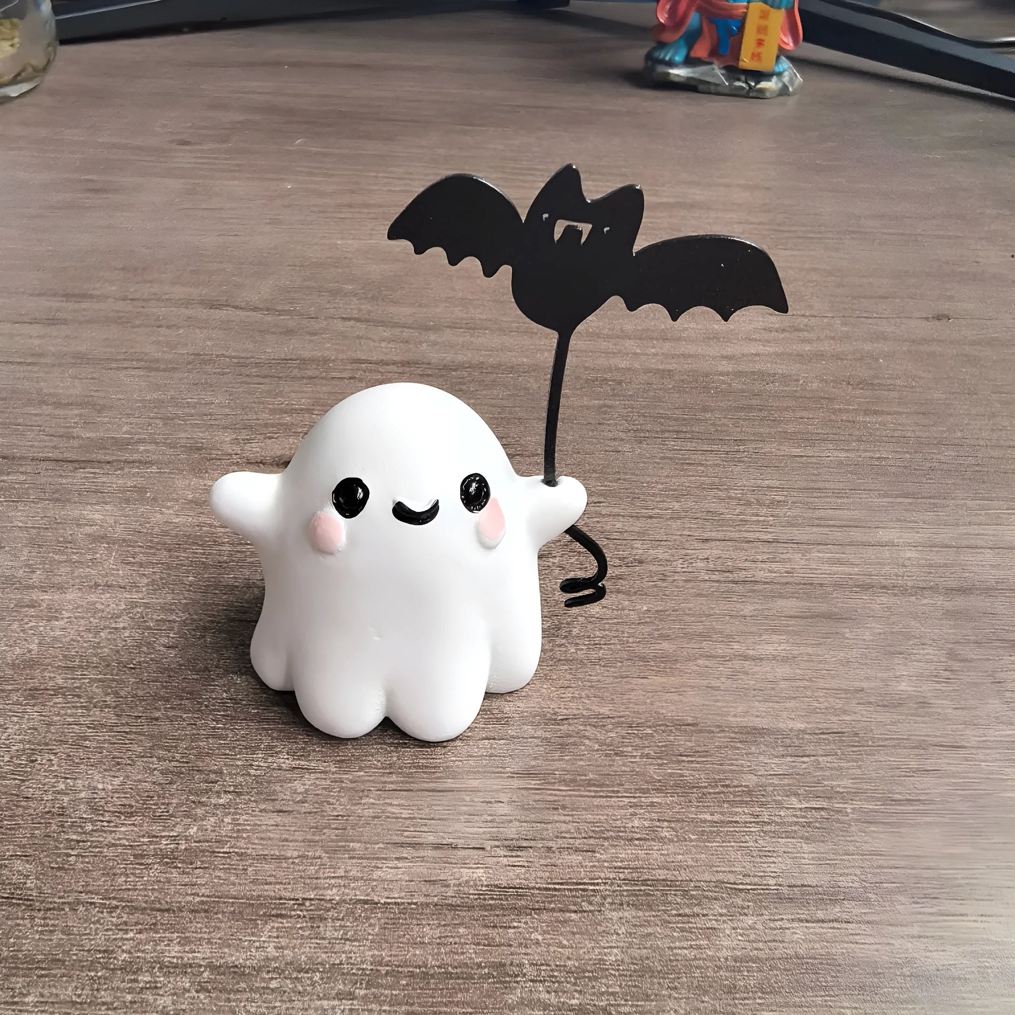 Miniature resin ghost statue walking a dog and holding a bat, Halloween decoration