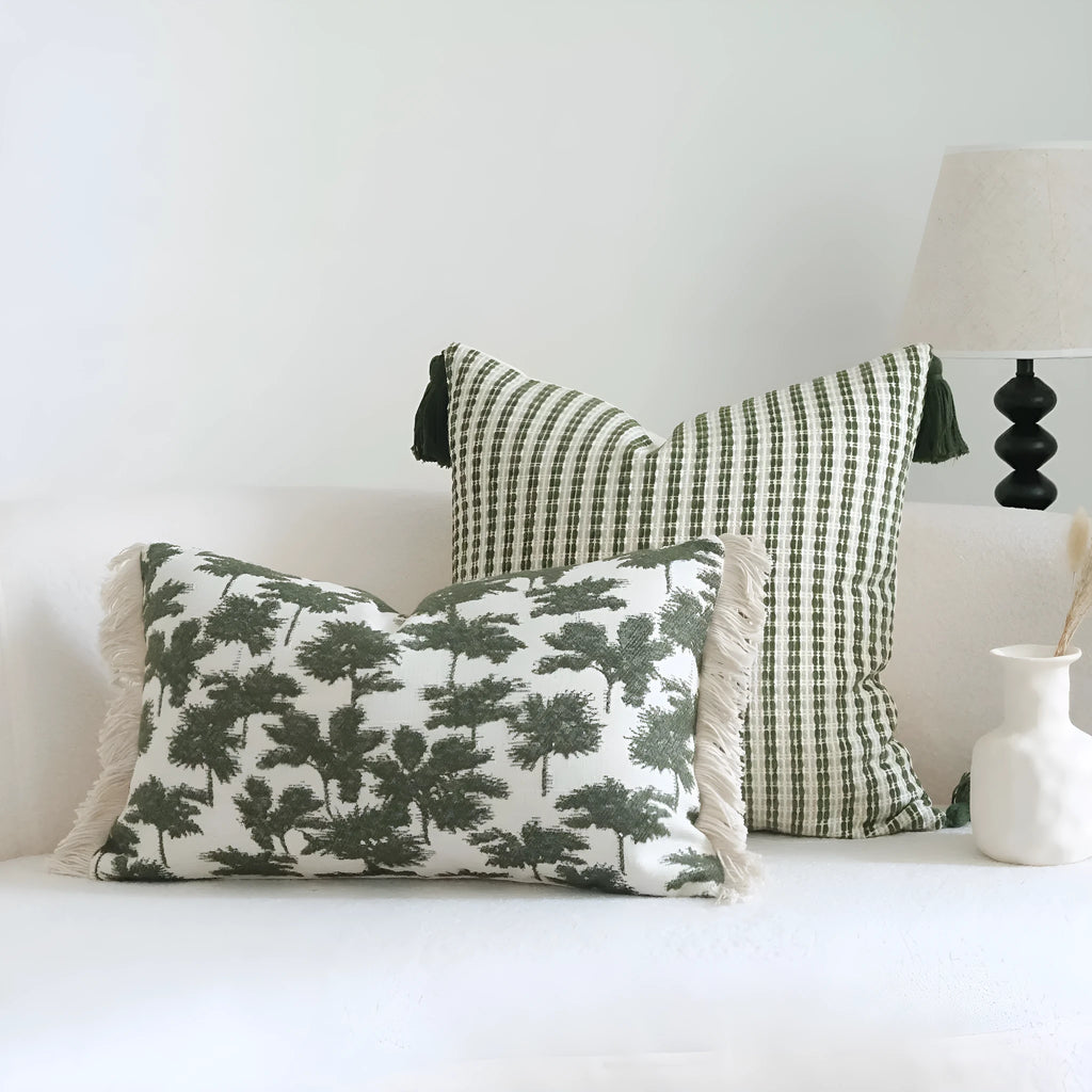 Green striped cotton linen hotel sample pillow with silk floss filler on a bed display.