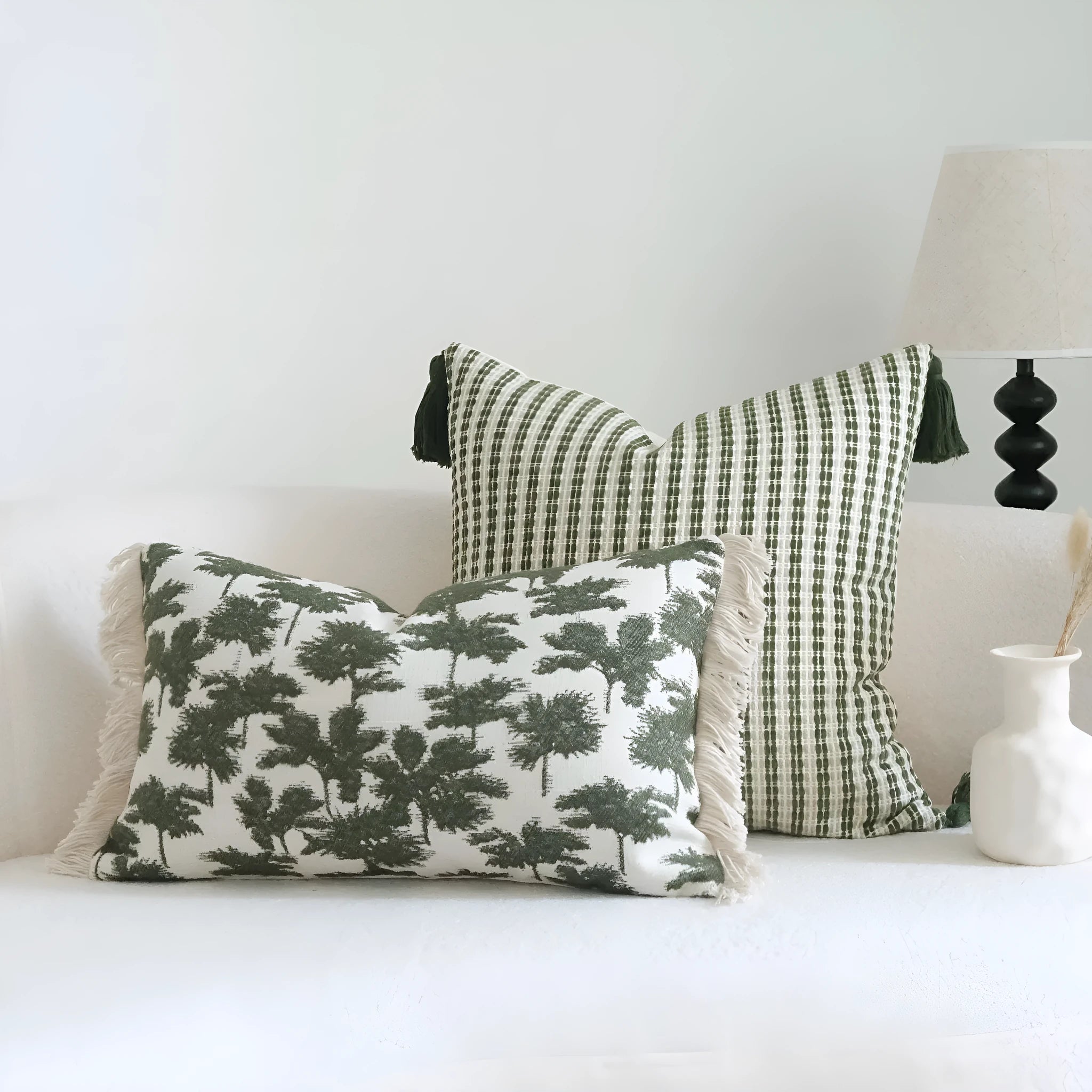 Green striped cotton linen hotel sample pillow with silk floss filler on a bed display.