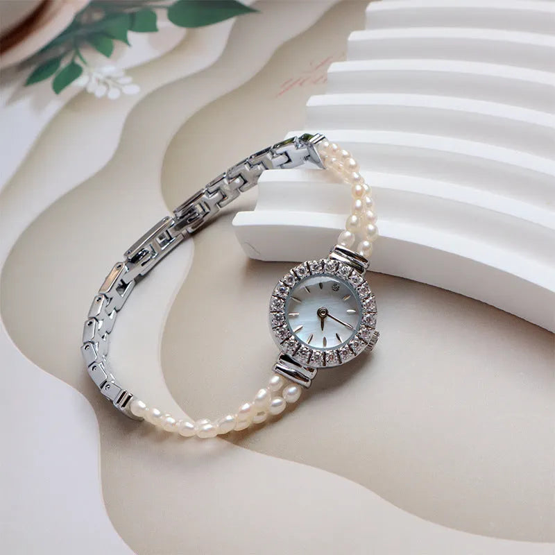 Women's light gold bracelet watch with freshwater pearl band and 18mm round dial