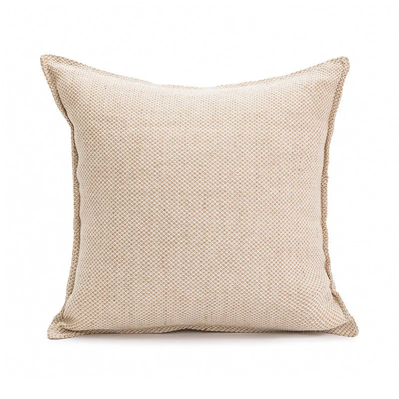Solid colour decorative cushion on a sofa, showing its square shape and pp cotton filling.