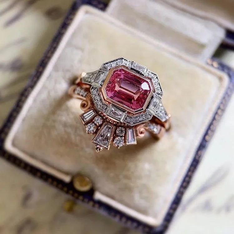 Women's rose gold colour alloy ring with geometric ruby-coloured centrepiece on finger