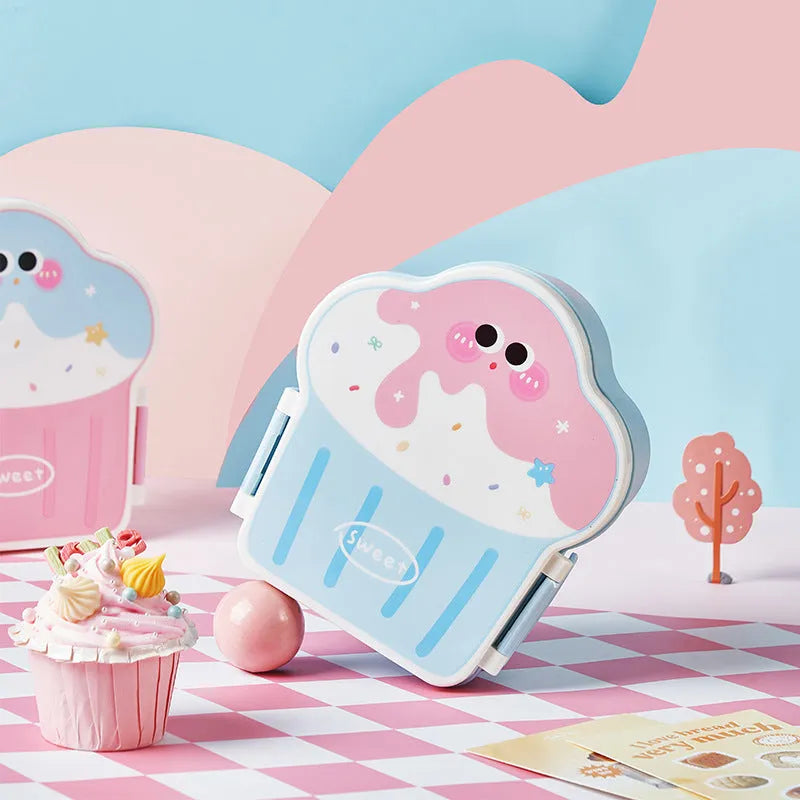 Pink and blue creative ice cream shaped plastic lunch box with spoon and fork on a table.