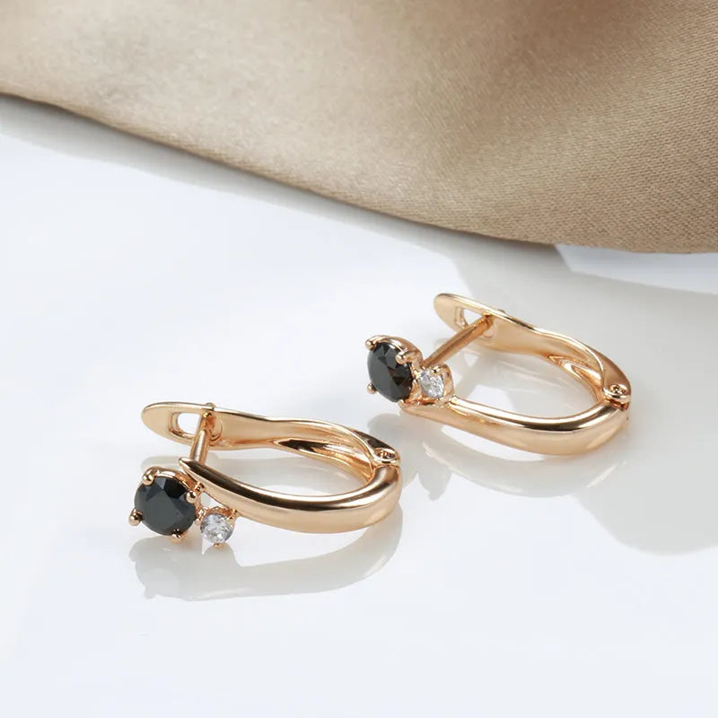 Gold drop-shaped women's earrings with a black agate stone inlay and retro geometric design.