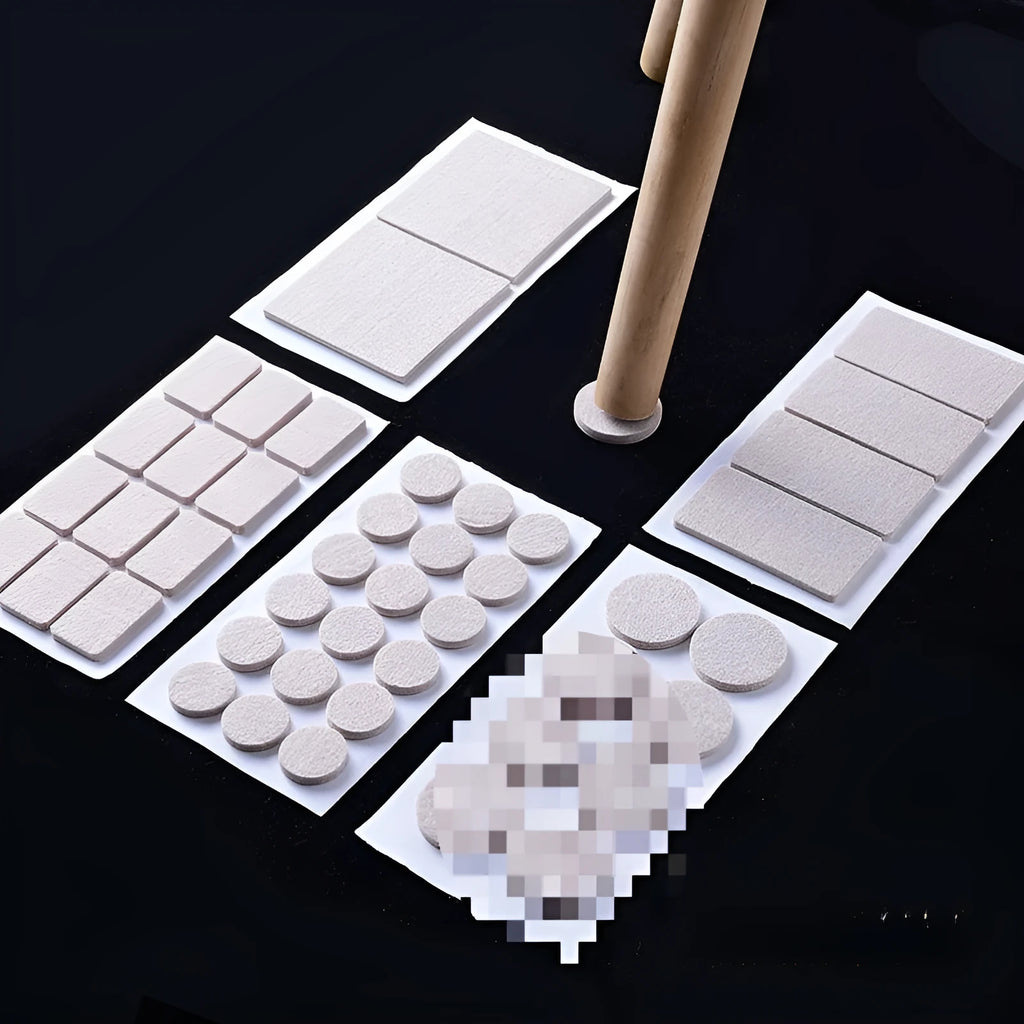 Beige plastic furniture leg protection pads in round and square shapes on wooden floor