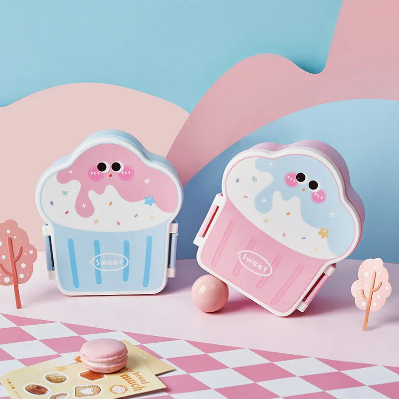 Pink and blue creative ice cream shaped plastic lunch box with spoon and fork on a table.