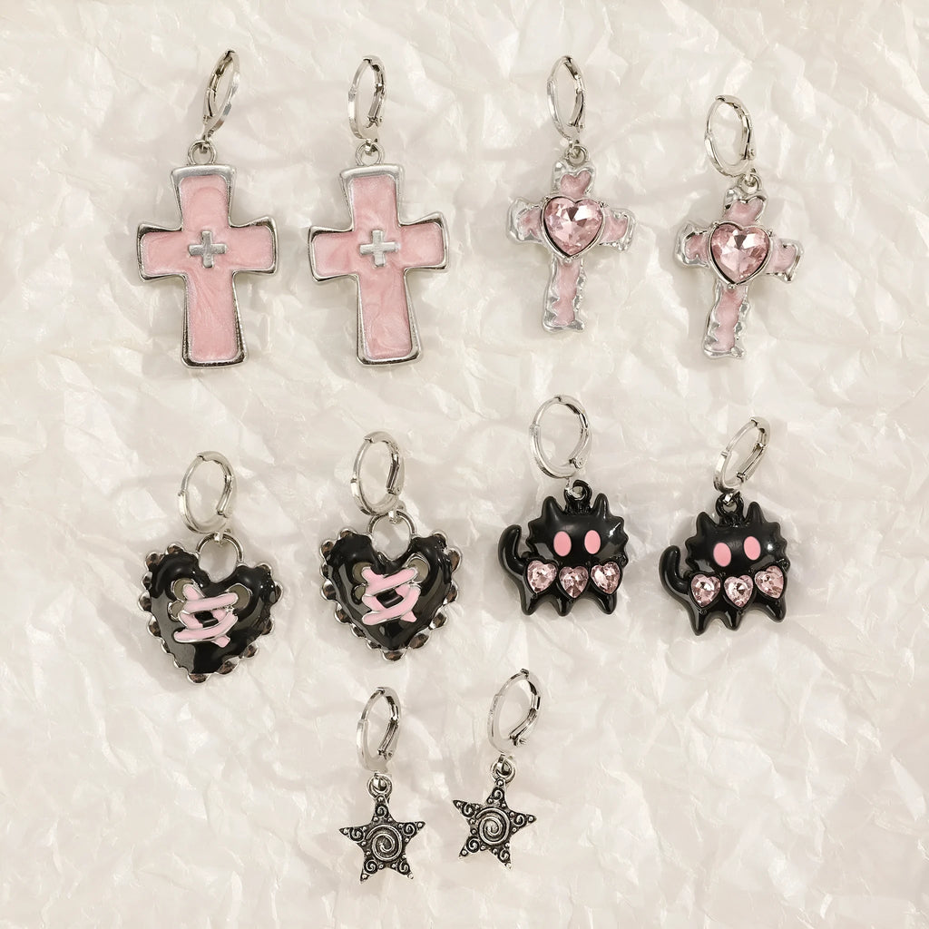 Women's alloy earrings showing cross, heart, and animal designs in white, black, and silver colour variations