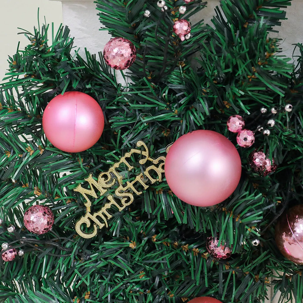 A long, pink artificial rattan Christmas garland with small fruits and leaves, shown draped decoratively.