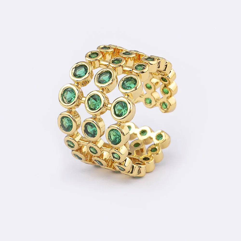 Copper wide band ring plated in 18K gold, fully set with green zircon stones.