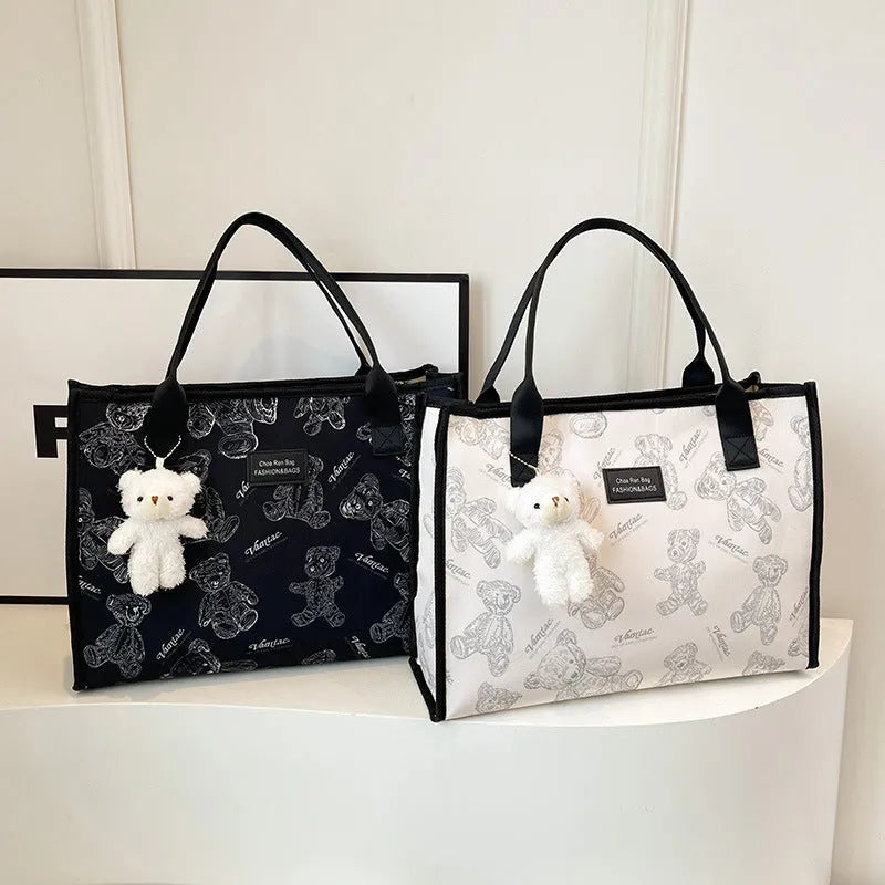 Women's canvas tote bag with printed rhombus pattern in black colour with pendant attachment