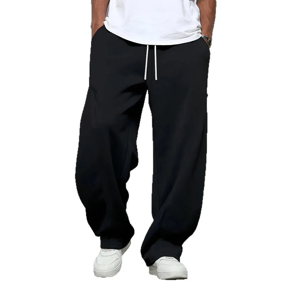 Men's grey casual trousers with drawstring waist and straight leg design on hanger