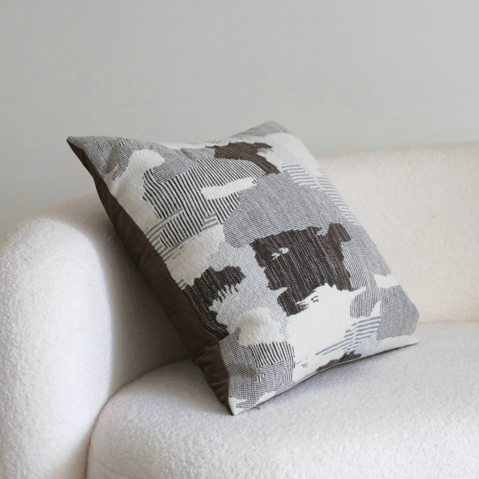 Coffee brown striped decorative cushion on a sofa in Chinese classical mid-century modern style.