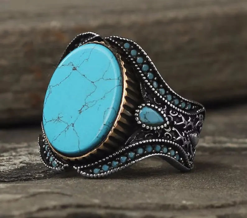 Men's round turquoise alloy ring with antique silver finish showing circular band design