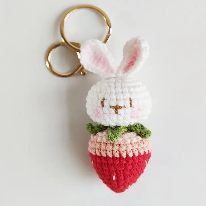 Hand-woven rabbit strawberry wire pendant with key attachment on white background