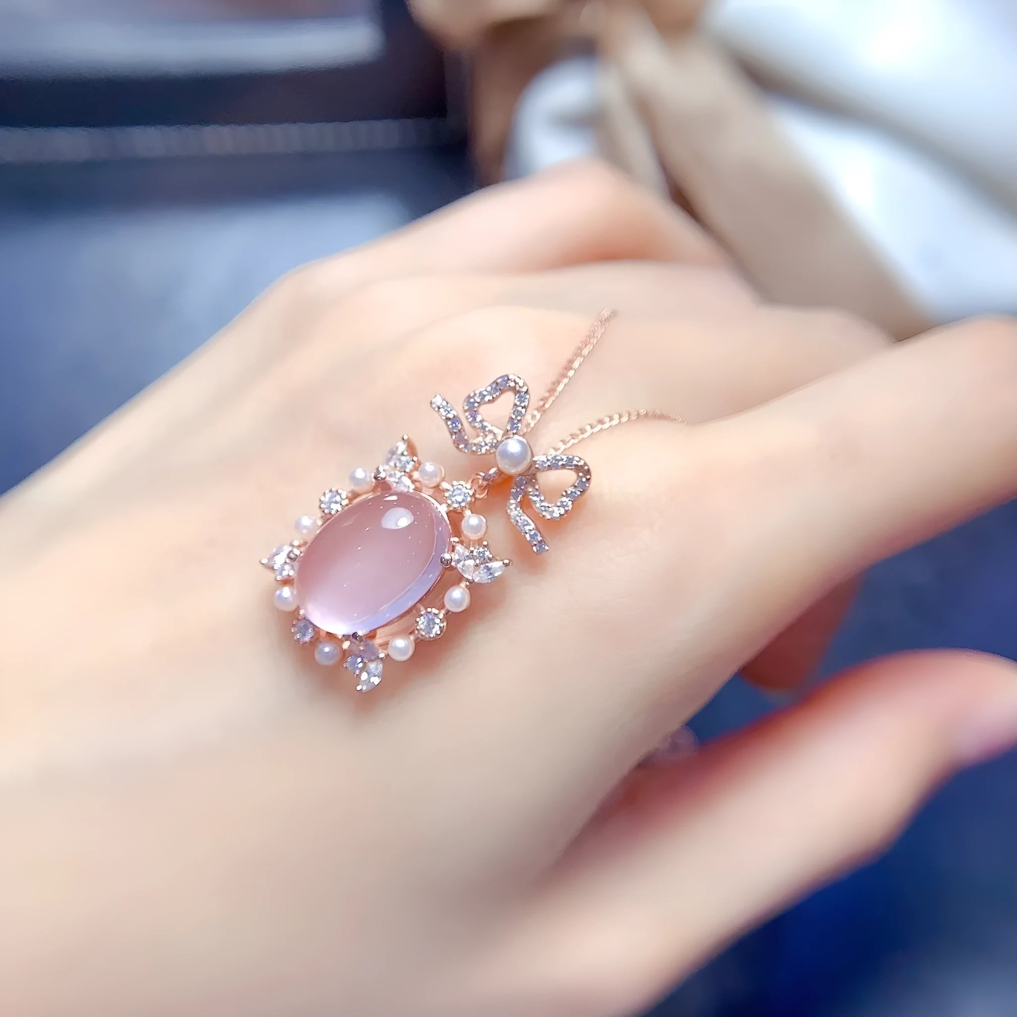 Pink rose quartz crystal pendant on silver necklace with rose gold plating geometric design