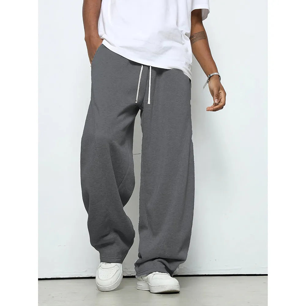 Men's grey casual trousers with drawstring waist and straight leg design on hanger