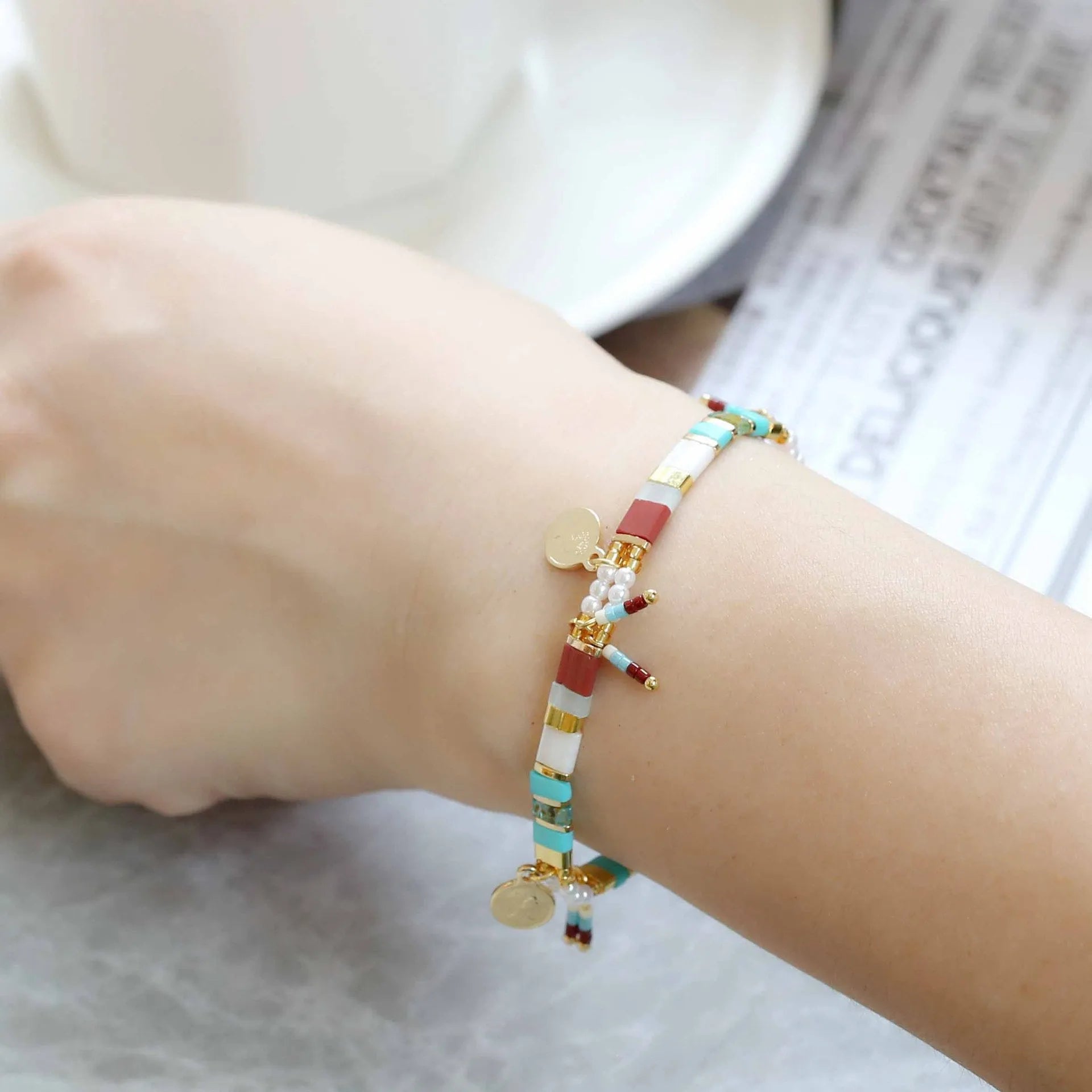 Women's imitation pearl beaded bracelet with glass coloured detailing in pearl lift colour options