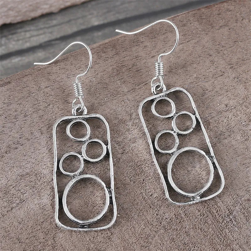 Round geometric earrings with irregular square designs in antique silver finish