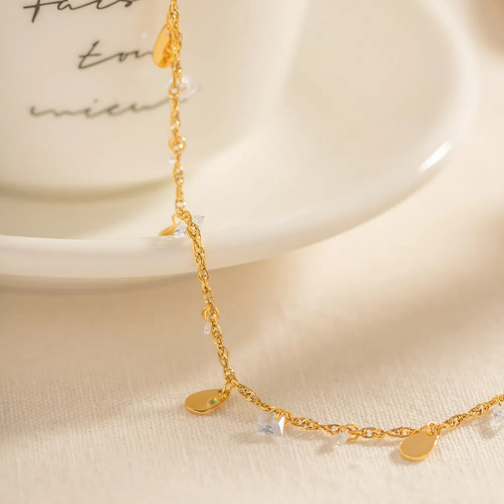 Women's stainless steel water drop tassel anklet with geometry shape design, colour JDAW2303012, on a white background