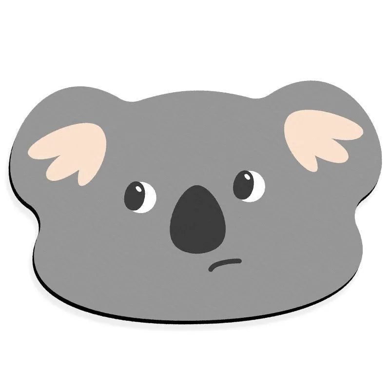 Cartoon animal diatom mud bathroom mat in Mr Brown Bear design on tiled floor.