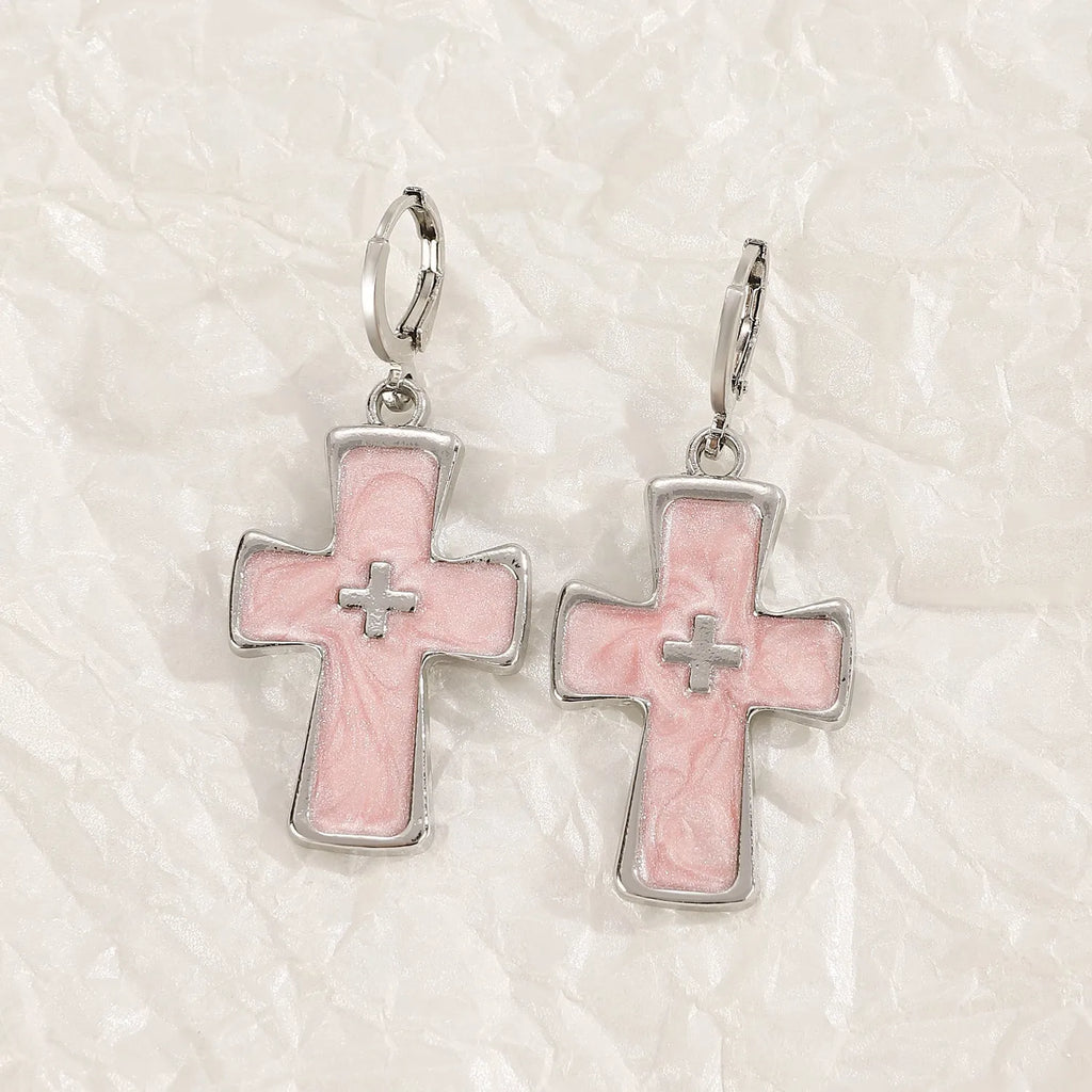 Women's alloy earrings showing cross, heart, and animal designs in white, black, and silver colour variations