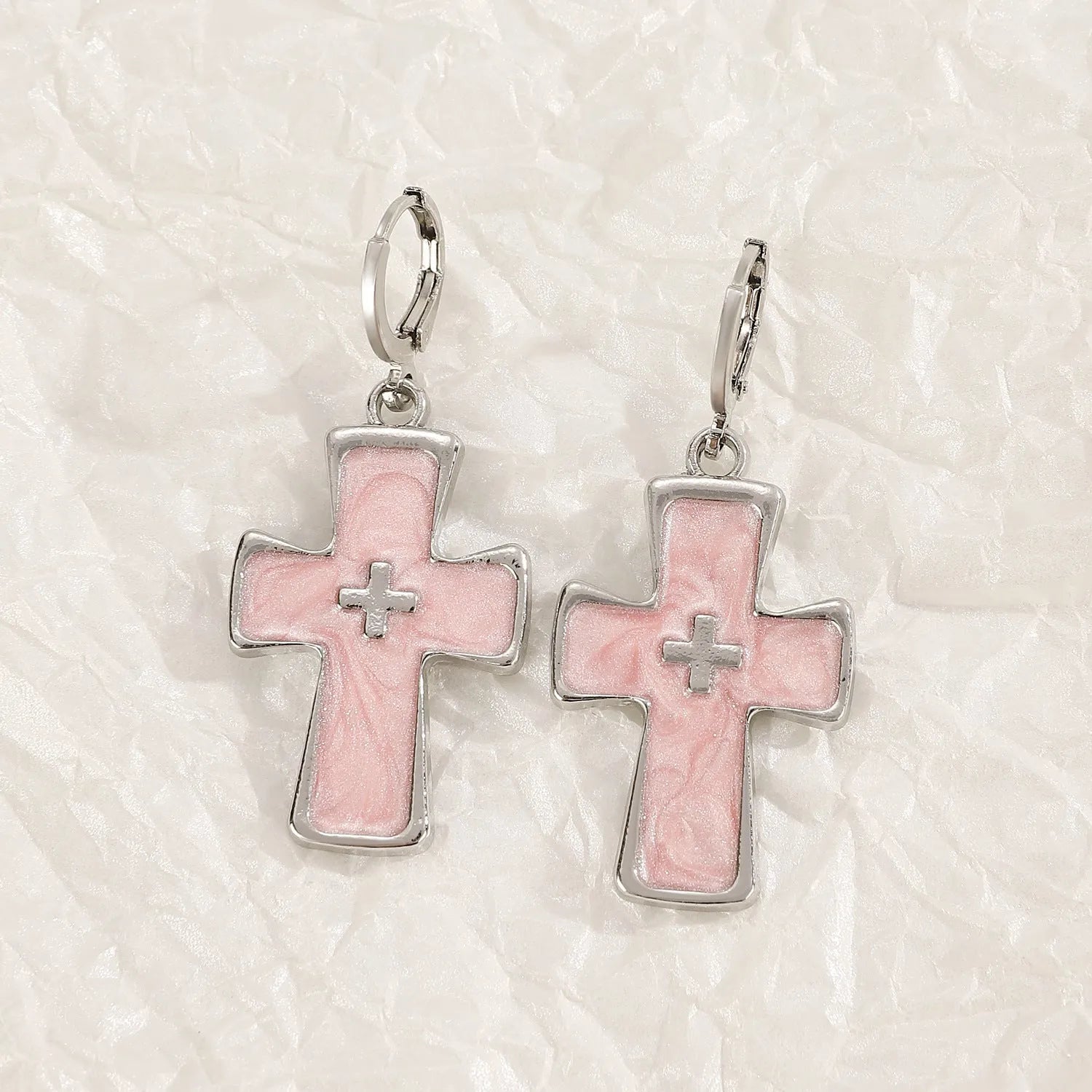 Women's alloy earrings showing cross, heart, and animal designs in white, black, and silver colour variations
