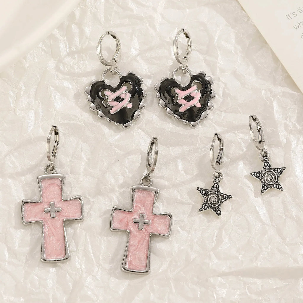 Women's alloy earrings showing cross, heart, and animal designs in white, black, and silver colour variations