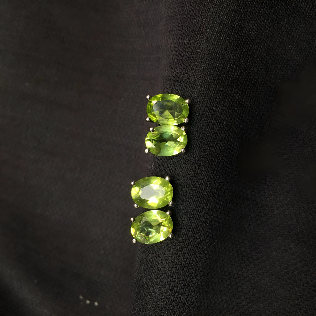 Natural grass green olivine stud earrings in S925 sterling silver with 6×8mm elliptical faceted gemstones.