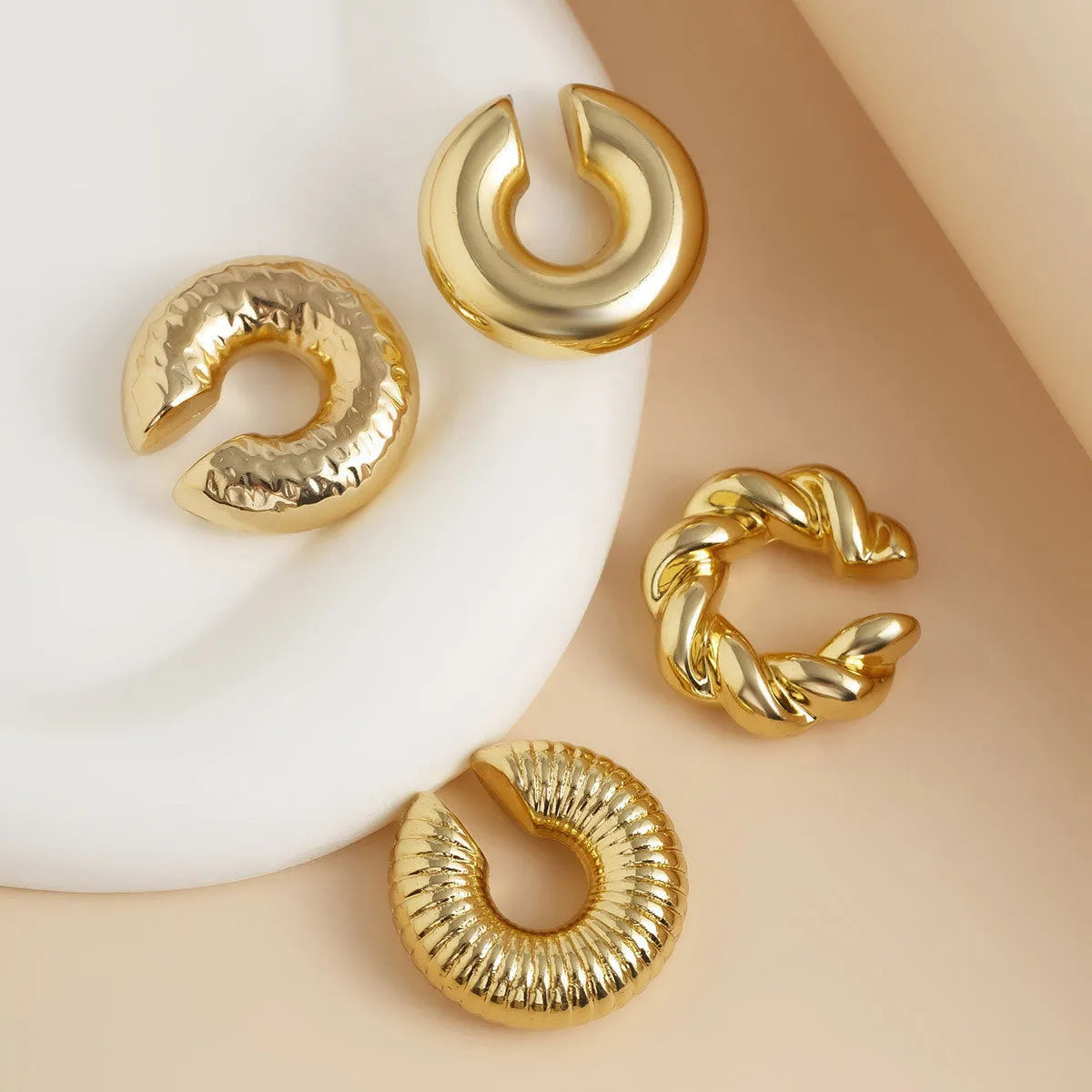 Set of four geometric non-pierced ear clips in gold and silver colours