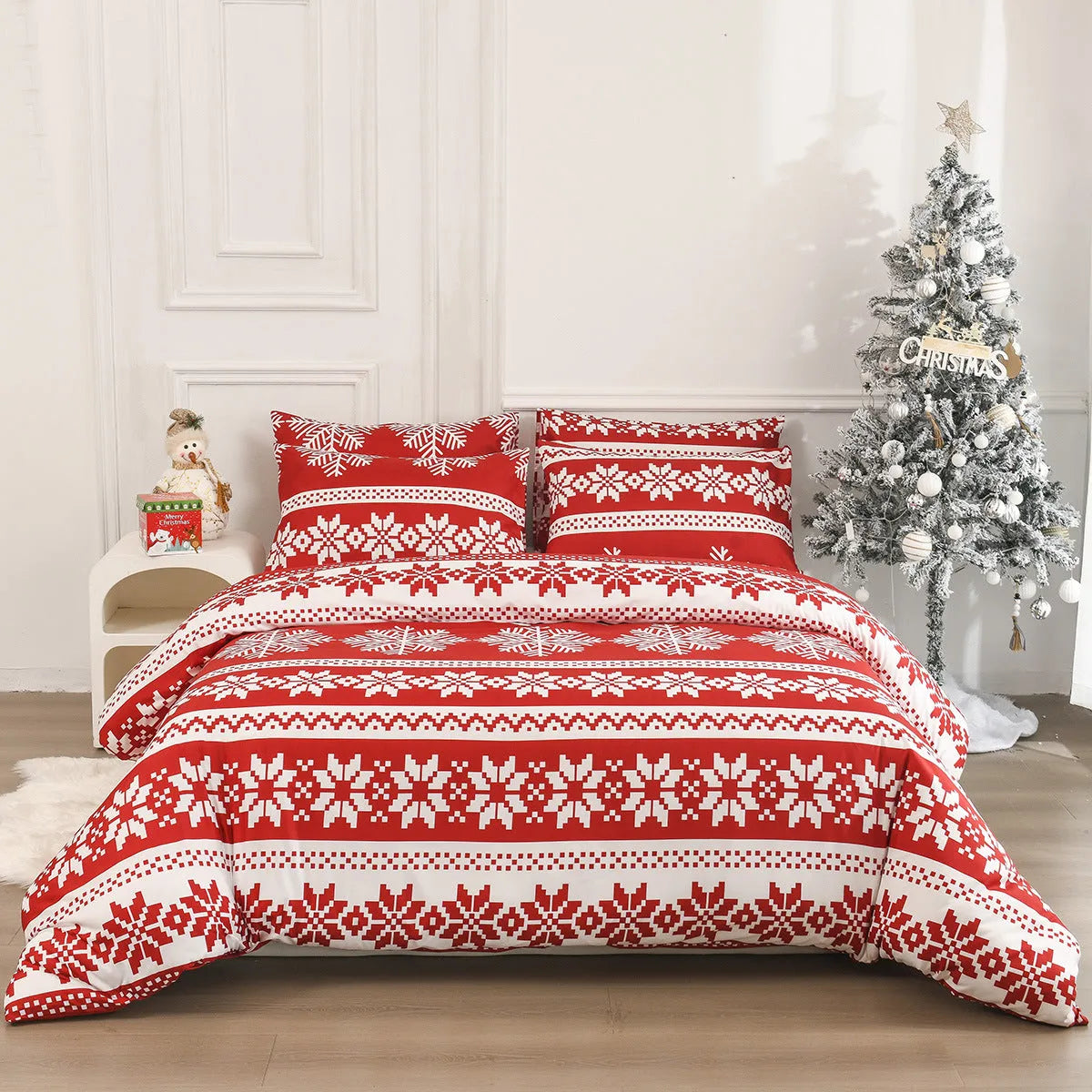 Winter Sleepers pattern three-piece bedding set in red on a bed