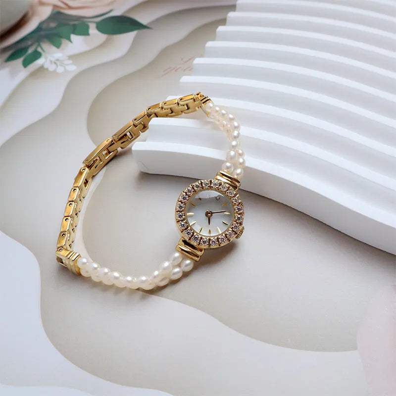 Women's light gold bracelet watch with freshwater pearl band and 18mm round dial