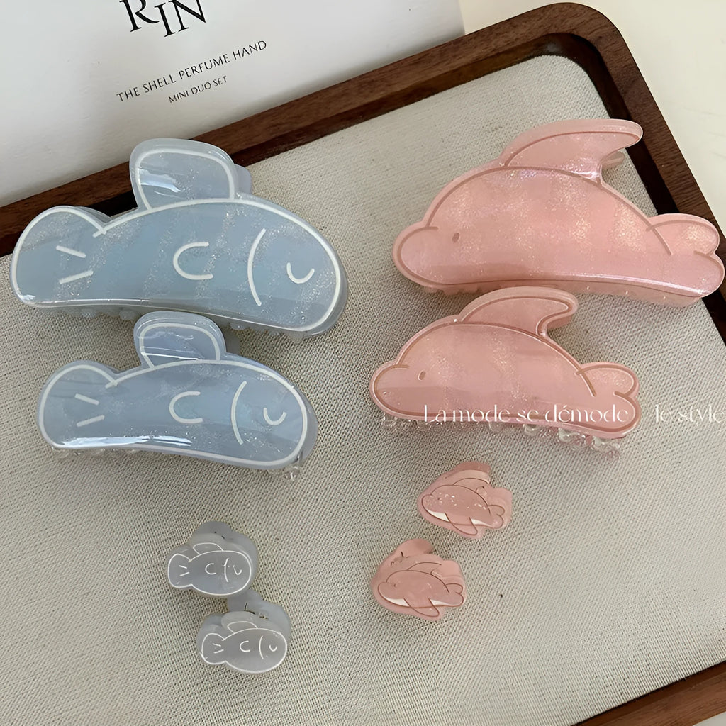 Women's dolphin grabber clip headdress in acetate material, available in blue and pink sizes, styled on hair