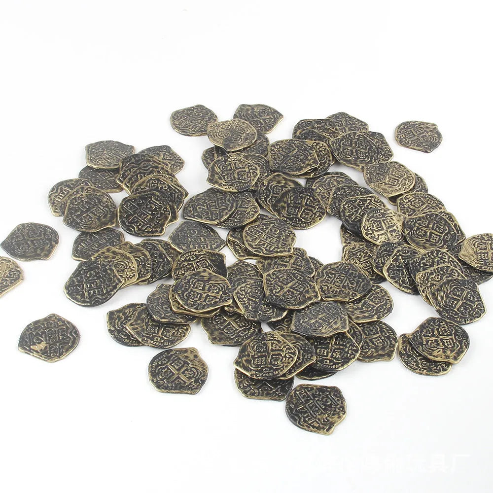 Set of 100 gold, silver and bronze coloured plastic replica Roman coins scattered on a surface.