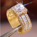 Geometric silver-fashion women's ring in gold or white colour on a grey background.