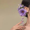 Floral tassel side clip hair accessory with pearl and linglan details on yellow background