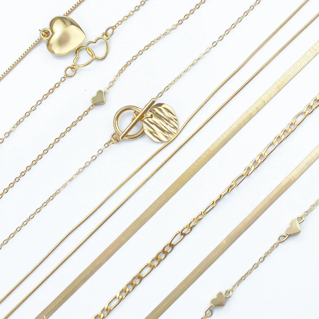 Ten gold electroplated necklaces with alloy pendants on adjustable snake bone chains