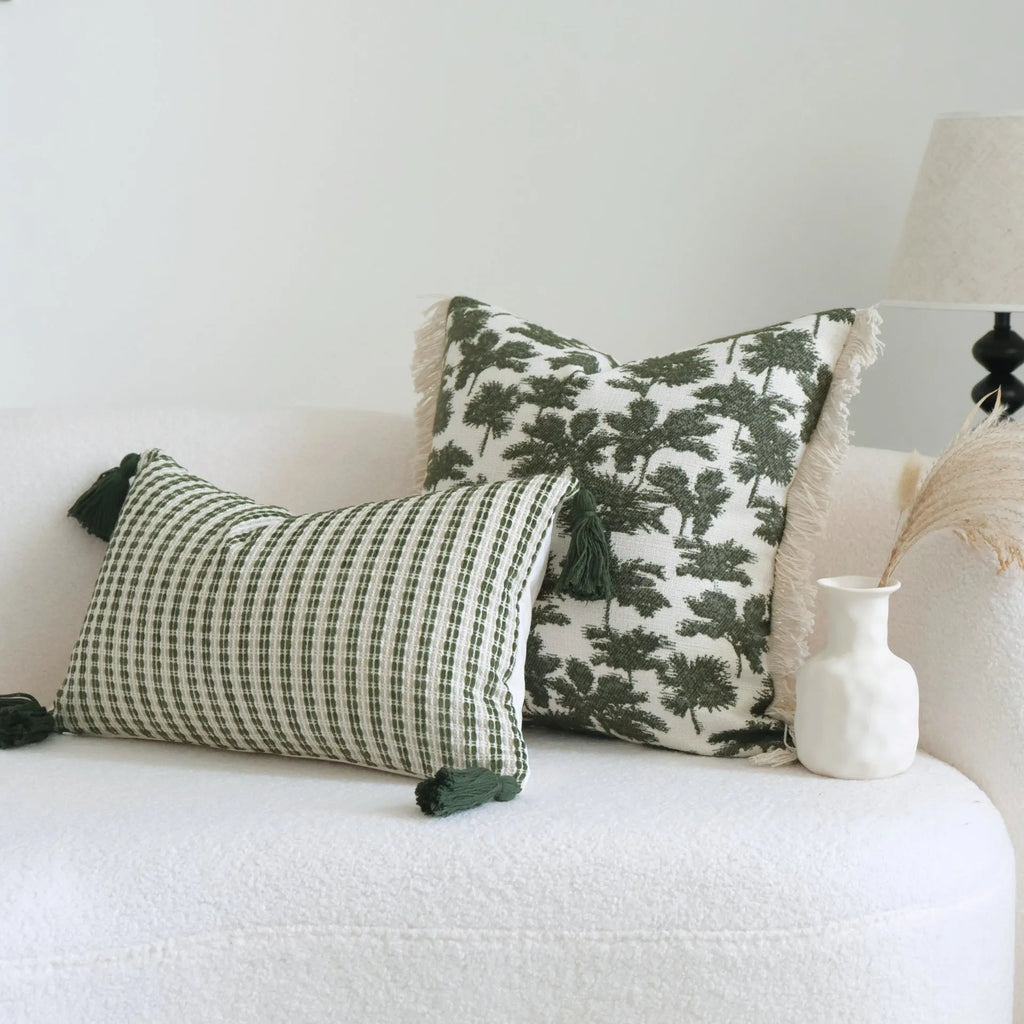 Green striped cotton linen hotel sample pillow with silk floss filler on a bed display.
