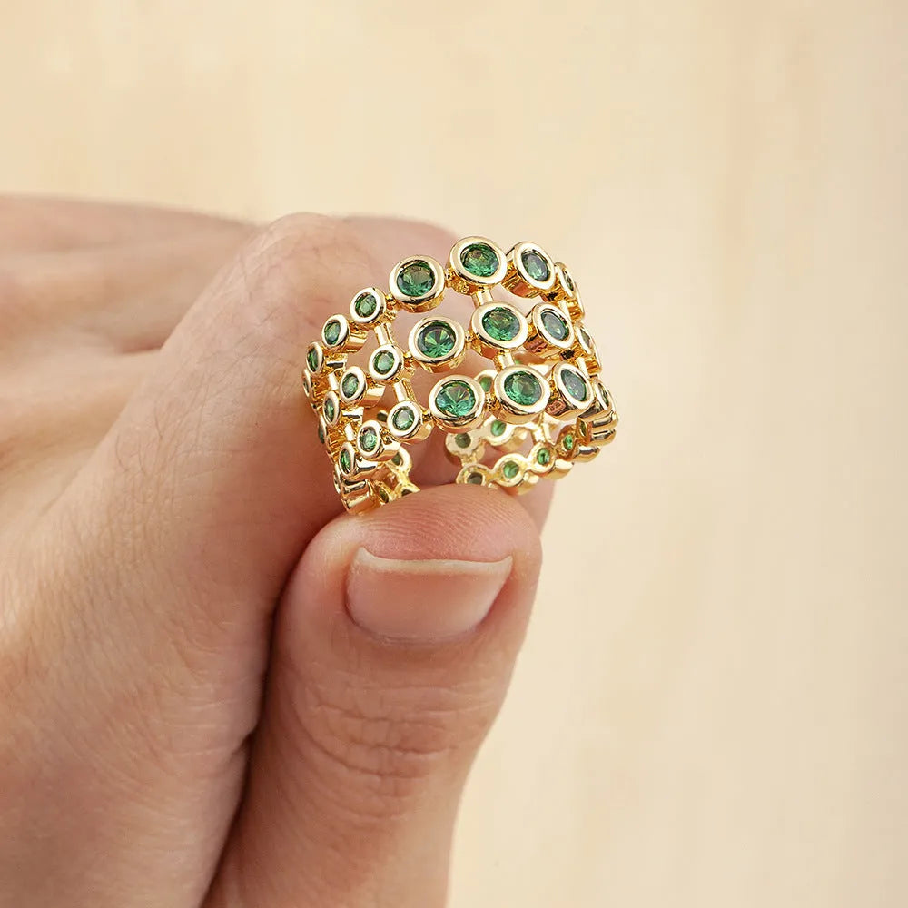 Copper wide band ring plated in 18K gold, fully set with green zircon stones.