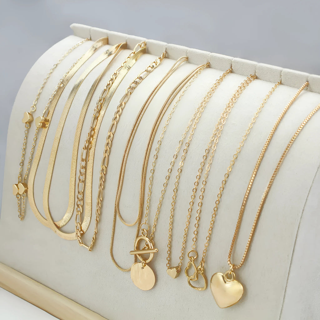 Ten gold electroplated necklaces with alloy pendants on adjustable snake bone chains