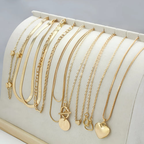 Ten gold electroplated necklaces with alloy pendants on adjustable snake bone chains
