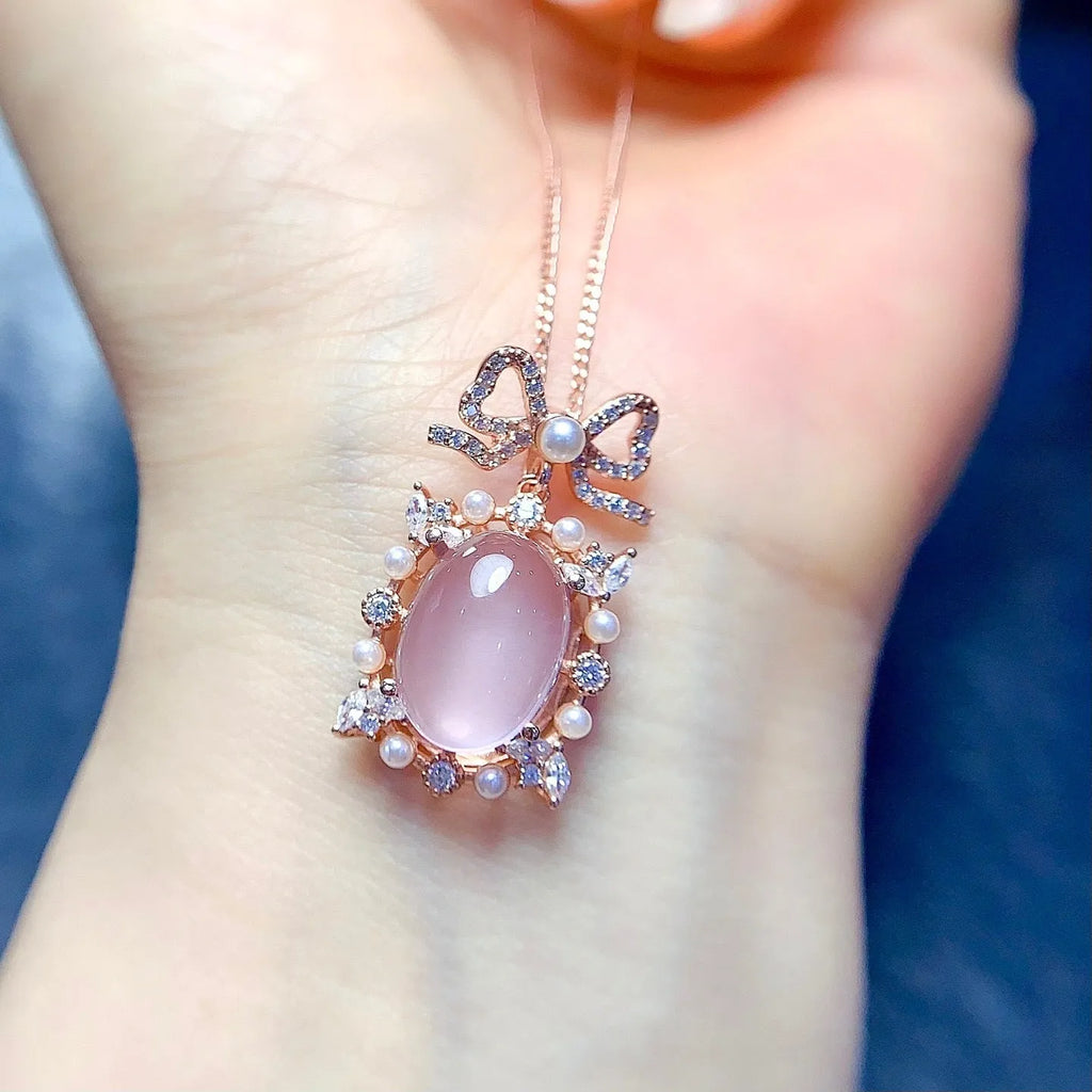 Pink rose quartz crystal pendant on silver necklace with rose gold plating geometric design