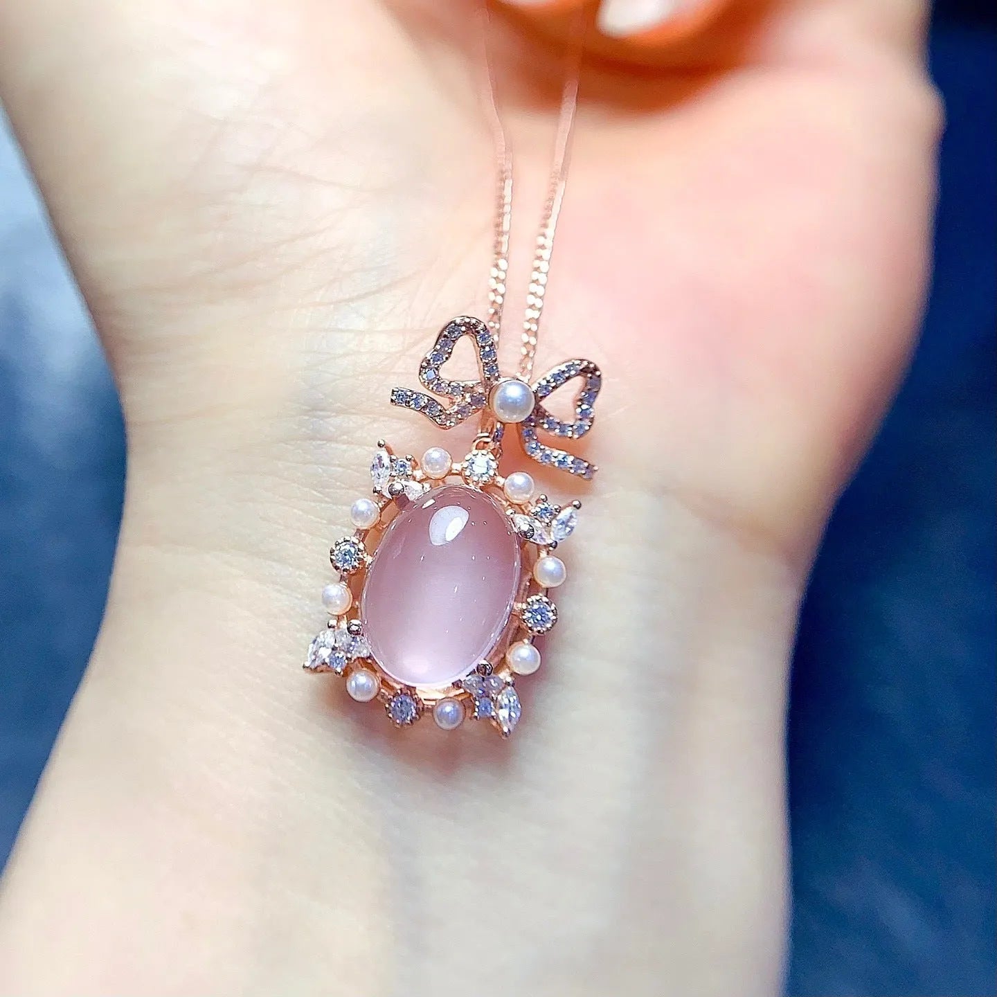 Pink rose quartz crystal pendant on silver necklace with rose gold plating geometric design