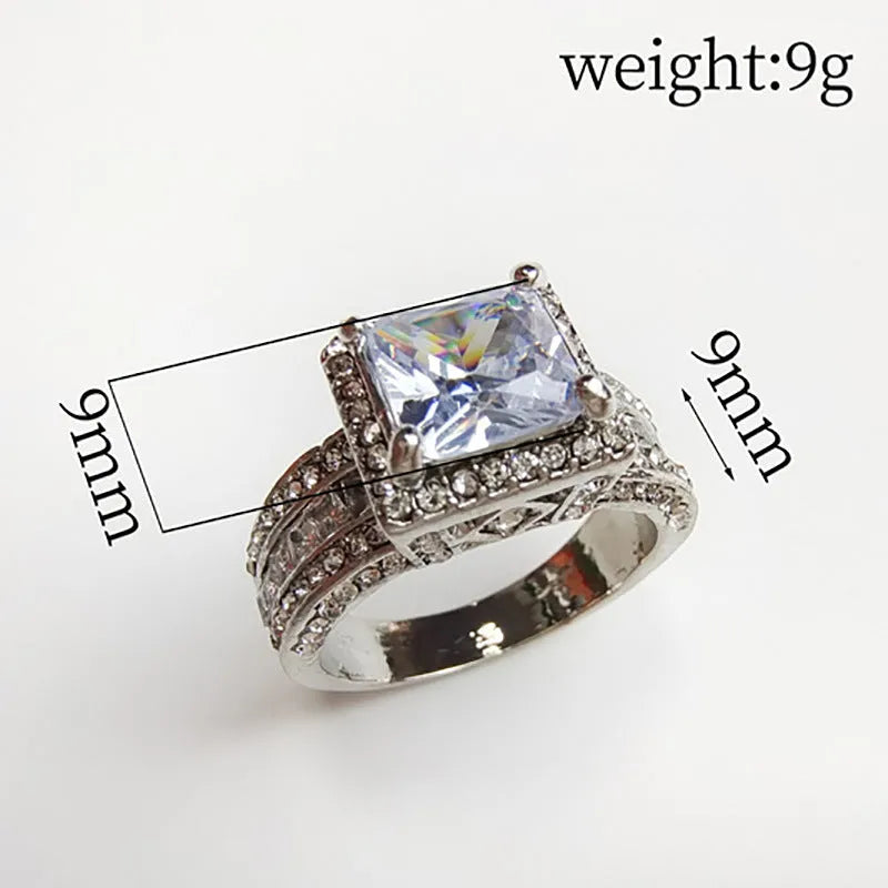 Geometric silver-fashion women's ring in gold or white colour on a grey background.