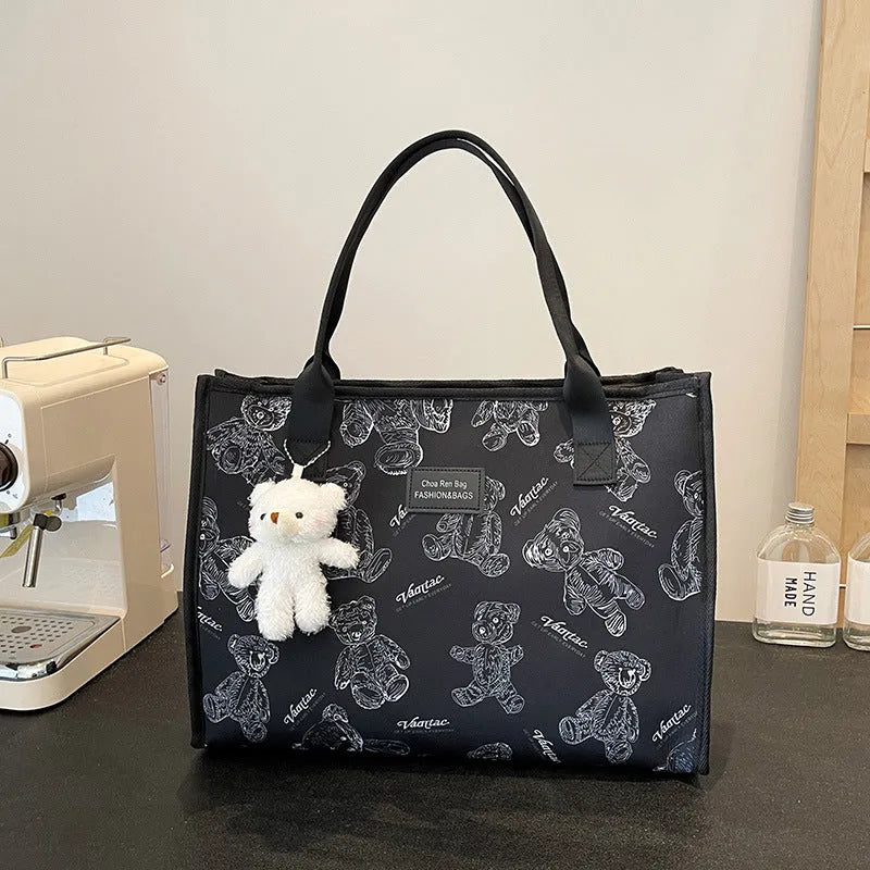 Women's canvas tote bag with printed rhombus pattern in black colour with pendant attachment