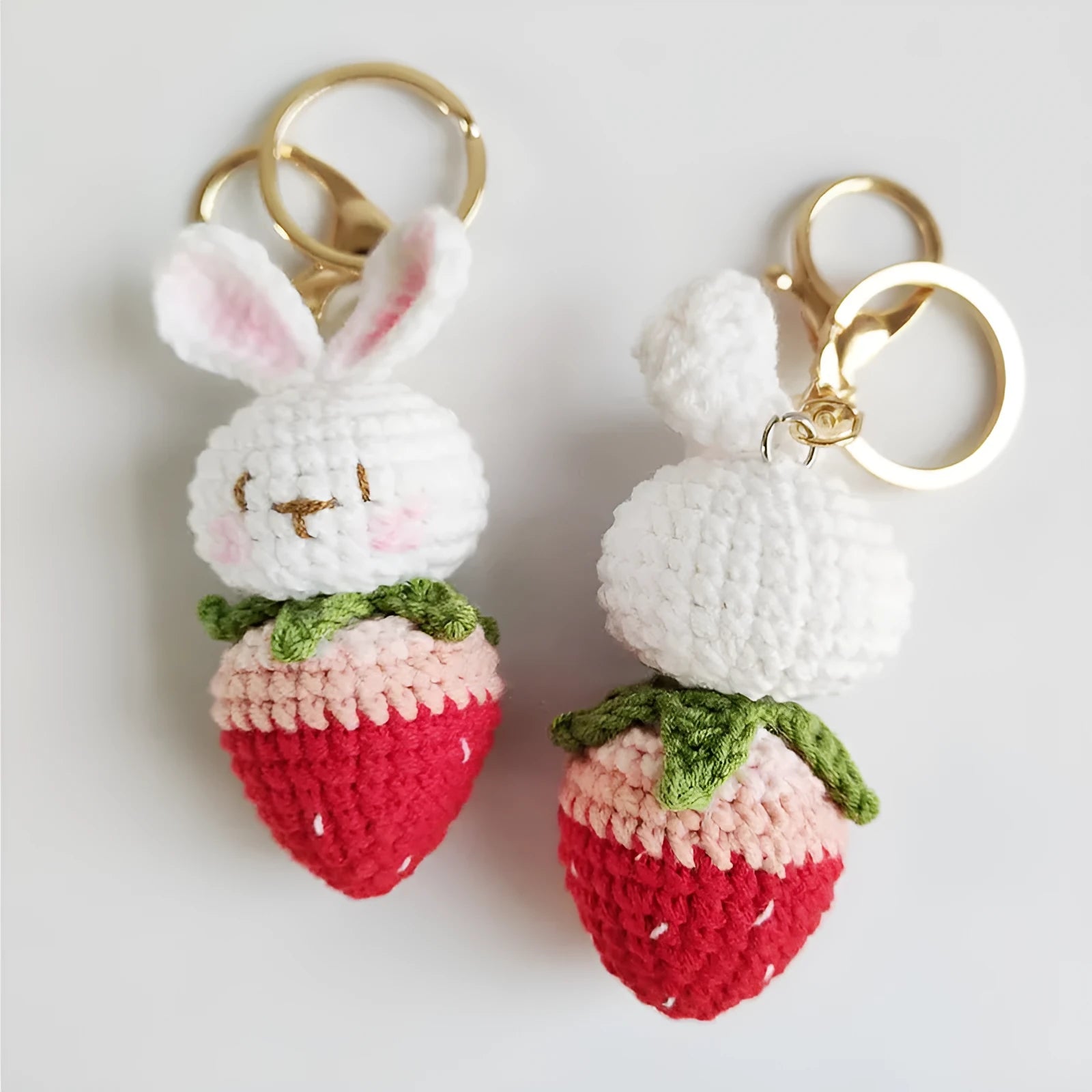 Hand-woven rabbit strawberry wire pendant with key attachment on white background
