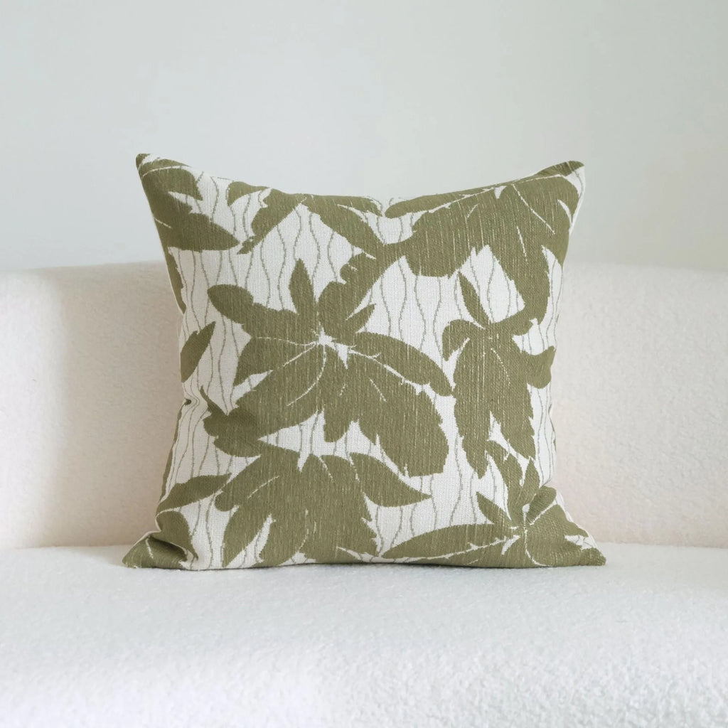 Green striped cotton linen hotel sample pillow with silk floss filler on a bed display.